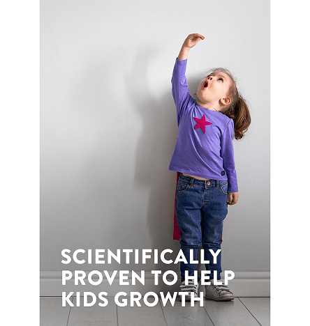A young girl in a purple top with her hand held high tries to measure her height with the text scientifically proven to help kids normal growth