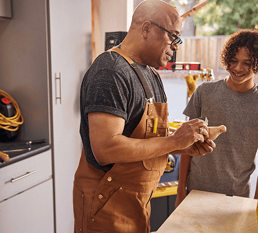 Man working with child in garage