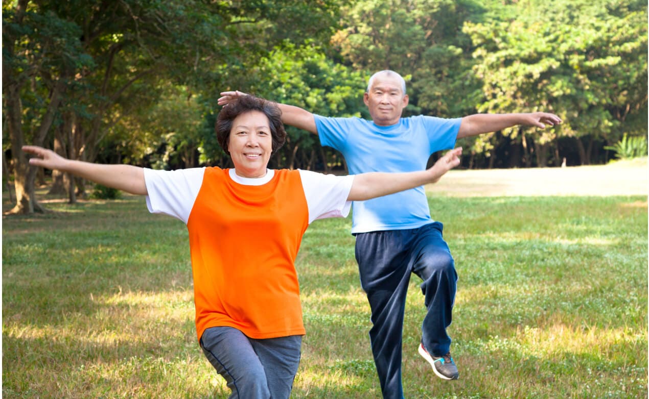 Two elderly people exercising together