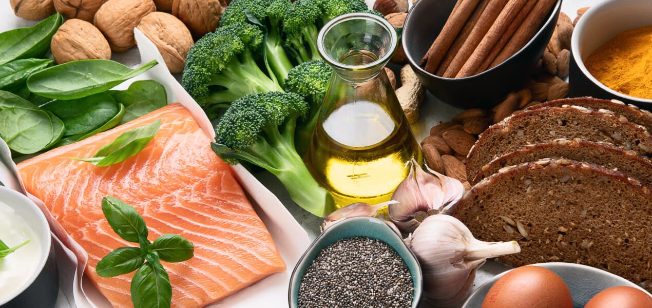 Fish, vegetables, chia seeds, bread, cinnamon, nuts, and other nutritious food items